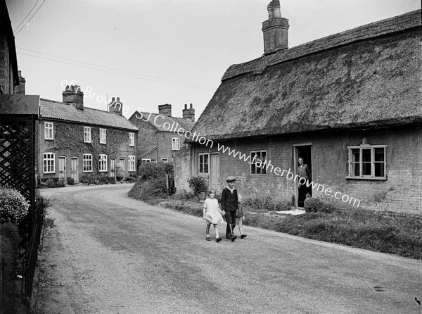 VILLAGE STREET WITH THATCHED COTTAGE